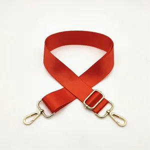 Detail of adjustable orange nylon replacement strap with golden metal swivel hooks