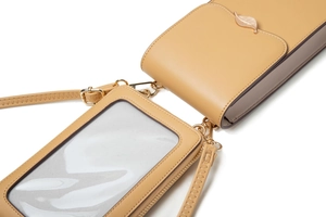 Detail of beige PU leather crossbody bag with metal leaf buckle and touch screen window