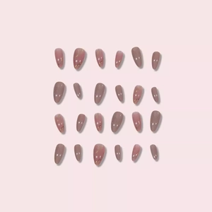 Almond-shaped press-on nails with marble texture, gold foil, and pink-purple tones