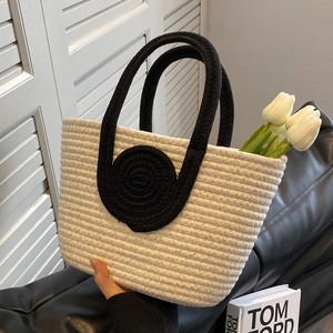 Contrast cotton rope woven tote bag with black handles and elegant beige knit texture