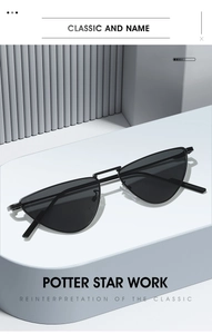 Detail of sleek black cat-eye sunglasses with thin metal frame on a geometric stand