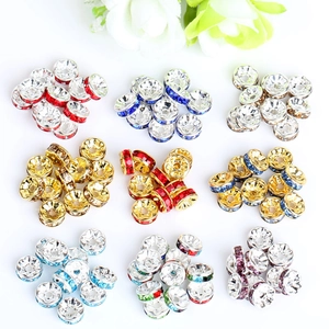 Detailed view of colorful rhinestone spacers with wavy edges for DIY jewelry making