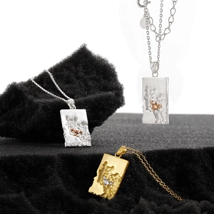Square textured pendant necklace set in silver and gold tones with inset stones