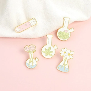 Pink heart beaker and floral lab flask enamel brooch pins in macaroon colors