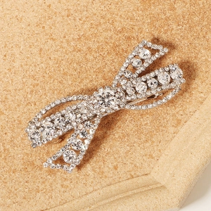 Luxurious silver bow hair clip with sparkling rhinestones for formal evening hairstyles