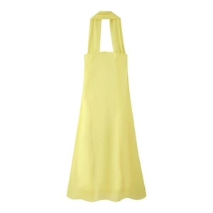 Detailed view of pale yellow halter neck dress with light chiffon fabric texture