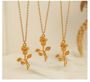 Detailed close-up of three elegant golden rose necklaces with intricate floral pendants