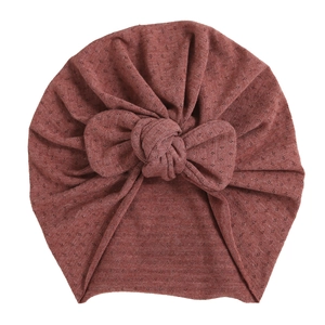 Brick red baby turban hat with polka dot texture and front knot detail for infants