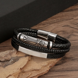 Detail view of multilayer braided leather bracelet with a silver stainless steel cross charm