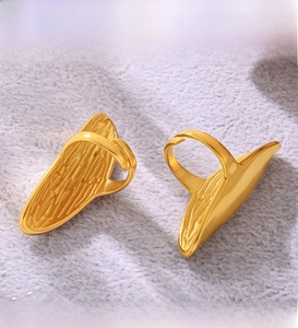 Detailed macro view of PVD electroplated gold irregular rings on soft plush fabric