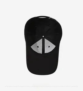 Interior view of black baseball cap showing cotton twill fabric and inner structure