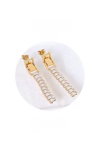 Detailed macro view of the layered gold metal earrings with rectangular crystals