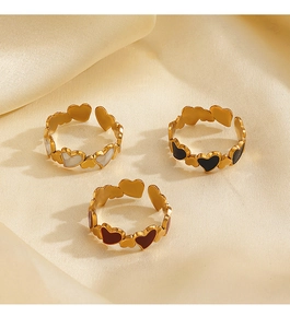 Three elegant heart-shaped open rings in gold finish with white, black, and red inserts