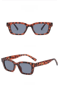 Detail view of retro tortoise shell rectangular sunglasses with grey lenses and gold accents