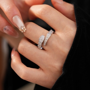 Detailed view of luxury snake-shaped silver ring with cubic zirconia on model finger