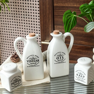 Minimalist white ceramic oil and vinegar dispenser set with pepper and salt shakers
