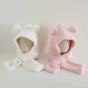 Detail of plush bear ear hooded scarves in white and pink showing soft fleece texture