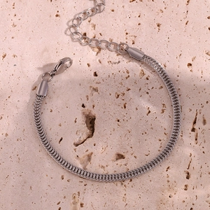 Detailed close-up of a silver stainless steel snake chain bracelet with lobster clasp