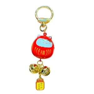Japanese Daruma bell keychain with lucky cat charms and golden Fortune inscriptions