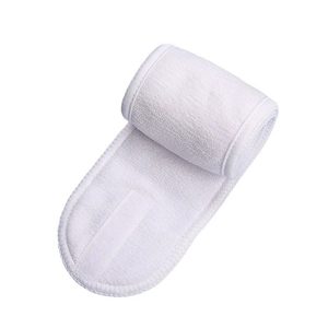 Close-up of white microfiber headband texture and adjustable hook-and-loop closure strap
