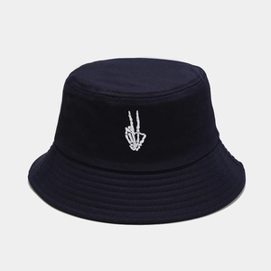 Close-up of skeleton hand embroidery on a navy blue cotton twill bucket hat