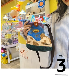 Detail of creative boot-shaped plush crossbody bag with colorful patchwork and embroidery