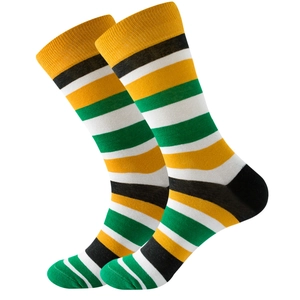 Detail shot of multi-color striped mid-calf socks in yellow black white and green knit