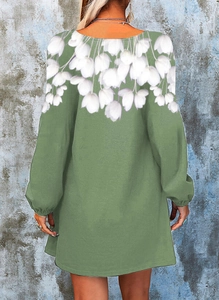 Back view of a green long-sleeved mini dress featuring a delicate white floral print pattern