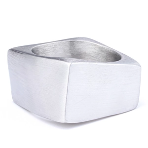 Macro detail of silver brushed metal finish on a geometric square ring for men