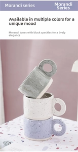 Close-up of Morandi ceramic mugs with large round handles and black speckle glaze