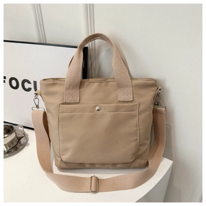 Detalle de bolso tote de oxford caqui con bolsillo de presión y correa ajustable