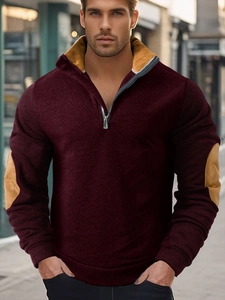 Detail of burgundy quarter-zip sweatshirt with khaki collar lining and elbow patches