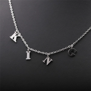 Polished stainless steel chain necklace with KING letter pendants on dark leather