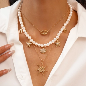 Bohemian three-layer gold necklace set with sea shells, pearls and starfish pendants