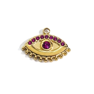 Macro detail of 14k gold-plated evil eye pendant with purple crystal rhinestones
