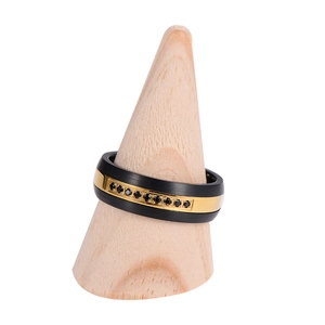 Macro detail of black brushed tungsten ring with gold center band and black zircon stones
