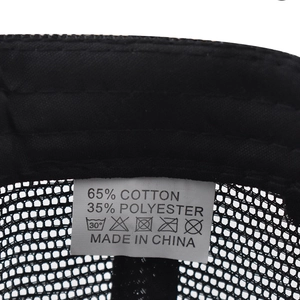 Detailed view of 65% cotton 35% polyester material label on black mesh baseball cap