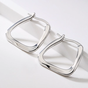 Minimalist silver geometric square earrings with a polished twisted metal design for women