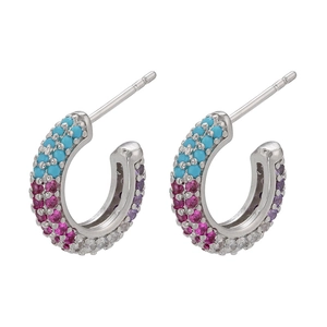 Close-up of C-shaped silver earrings with three rows of multi-color micro-pave zircons