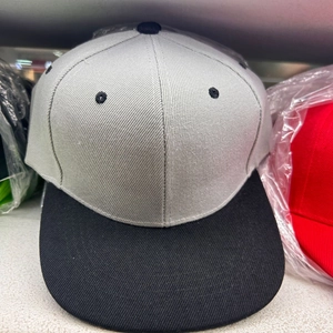 Detail shot of light grey and black flat brim hip hop cap with breathable embroidered eyelets