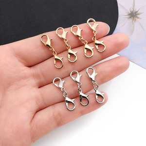 Dual-headed lobster clasps for jewelry in gold and silver finish, held in hand