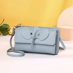 Detail of light blue elephant-shaped crossbody bag made of soft PU leather with dry flowers