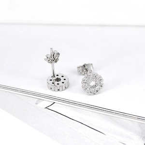 Macro shot of silver geometric stud earrings with micro-pave cubic zirconia crystals