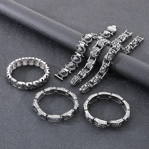 Retro punk gothic silver bracelets and skull rings set with floral engraved patterns