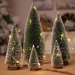 Mini snowy Christmas trees with LED lights and wooden bases for holiday tabletop decor