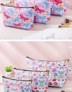Detail view of printed waterproof PU cosmetic bags in various sizes with floral patterns