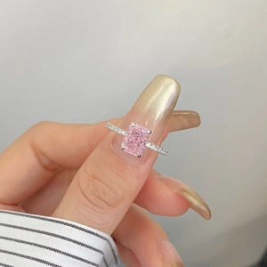 Close-up of radiant cut pink gemstone ring with sparkling micro-pave diamond setting