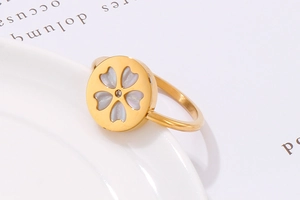 Detail of gold stainless steel ring with white shell cherry blossom and zircon stone