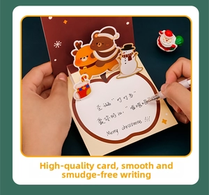 Close-up of handwriting on a 3D pop-up Christmas card with reindeer and bear designs