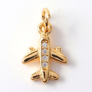 Detail of gold airplane pendant charm with four clear cubic zirconia stones for jewelry DIY